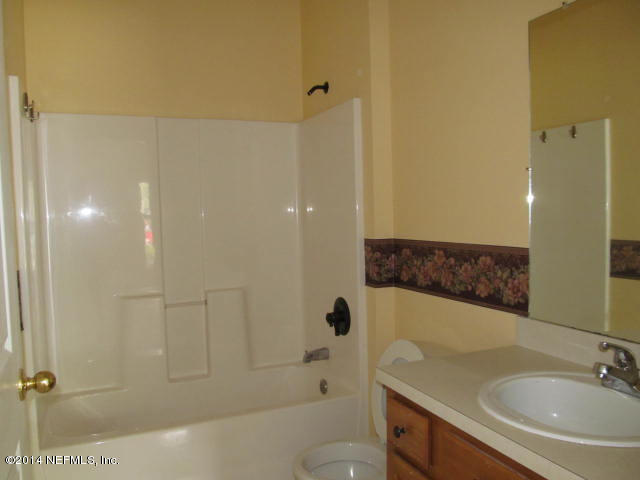 3641 Kirkpatrick Circle, Unit 1 Jacksonville, FL 32210 - Photo 10 of 11 a bathroom with a sink a toilet and shower