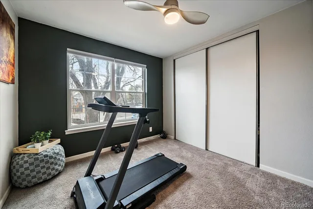 a room with gym equipment and a large window