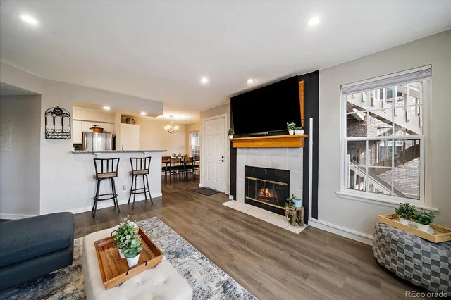 a living room with furniture a fireplace and a flat screen tv