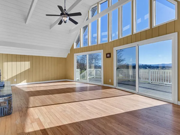 an empty room with windows and closet
