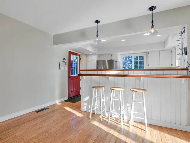 a view of a livingroom with an empty room and windows