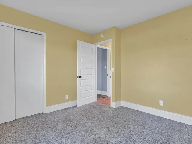 a view of a house with a big yard and large trees