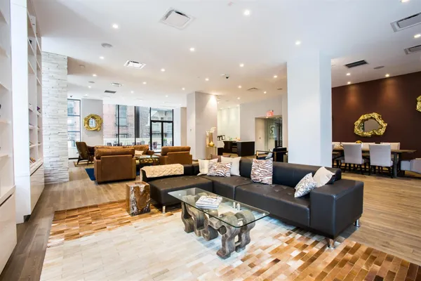 a living room with furniture kitchen view and a table
