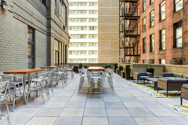 a view of a patio with dining table and chairs