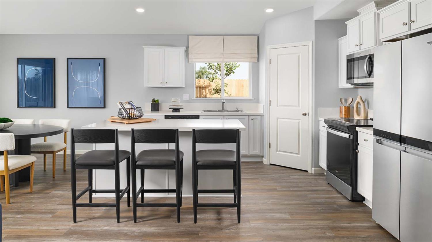 1657 Pacific Drive Los Banos, CA 93635 - Photo 5 of 10 a kitchen with stainless steel appliances granite countertop a dining table chairs refrigerator and sink