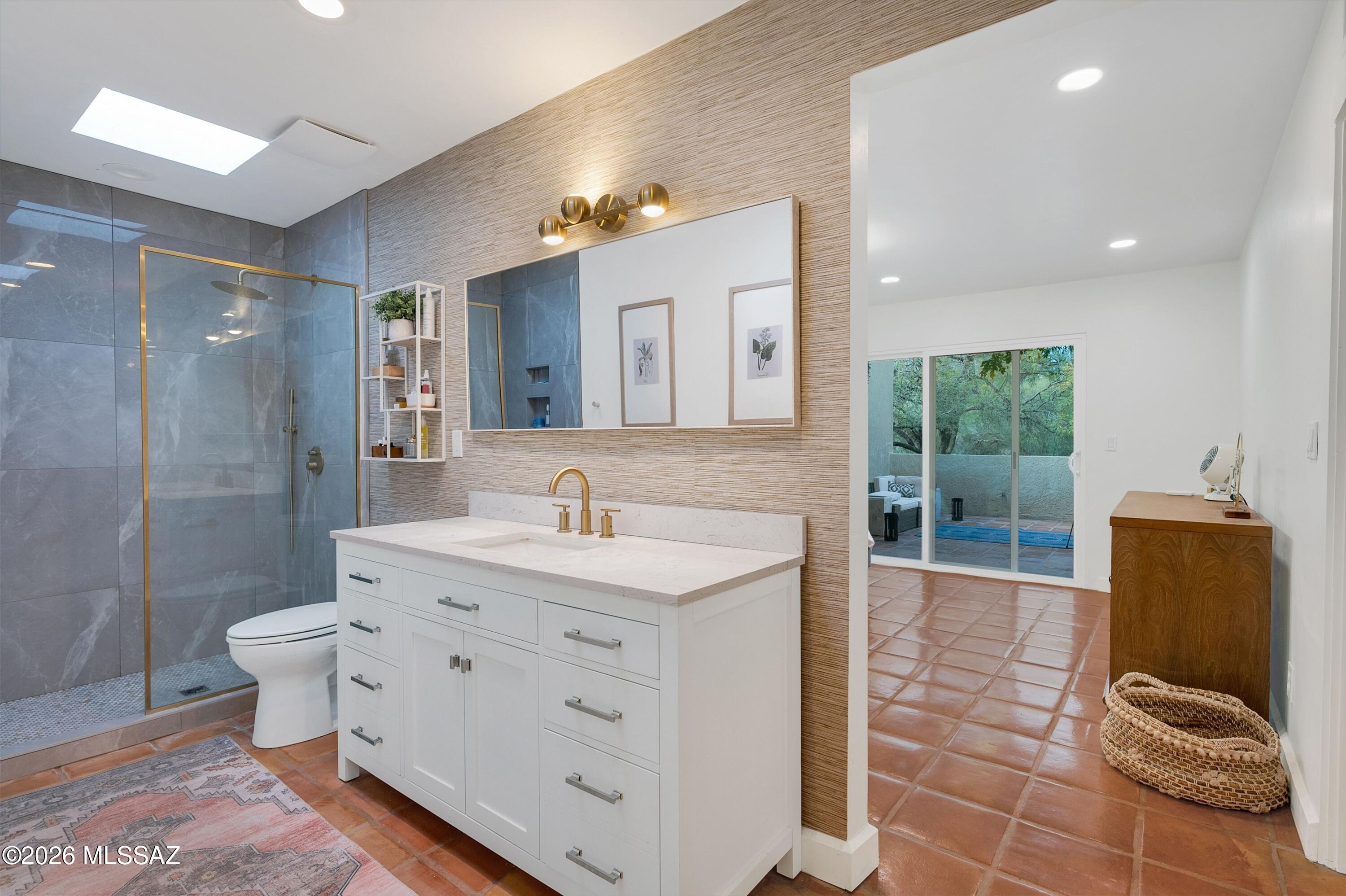 6941 East Rivercrest Road Tucson, AZ 85750 - Photo 14 of 32 a spacious bathroom with a double vanity sink toilet and a mirror