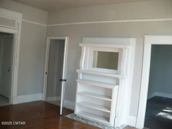 a view of bedroom with wooden floor