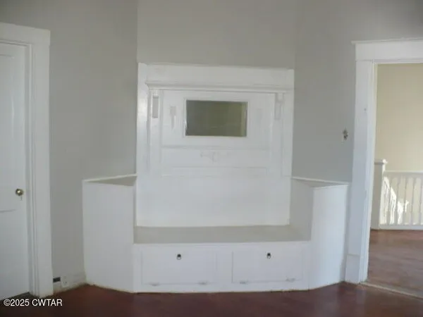 a view of front door with wooden floor