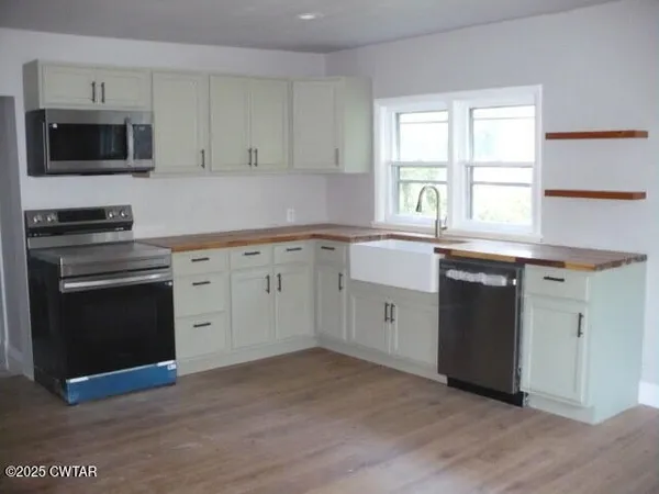 a kitchen with a sink stove and microwave