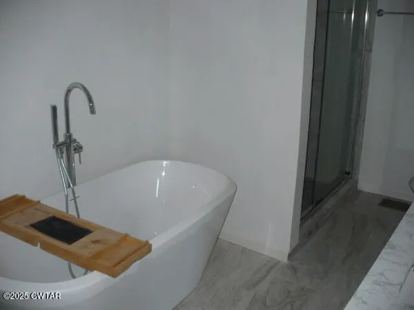 a white bath tub sitting in a bathroom