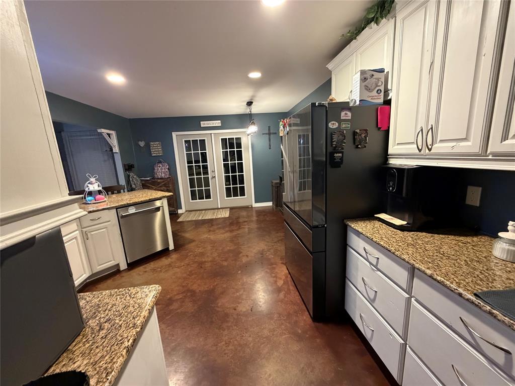 128 Staton Drive Haughton, LA 71037 - Photo 11 of 29 a kitchen with stainless steel appliances granite countertop a refrigerator and a sink