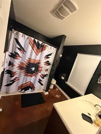 a bathroom with a toilet and a mirror