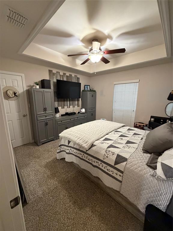 128 Staton Drive Haughton, LA 71037 - Photo 24 of 29 a bedroom with a large bed a flat tv screen and a ceiling fan
