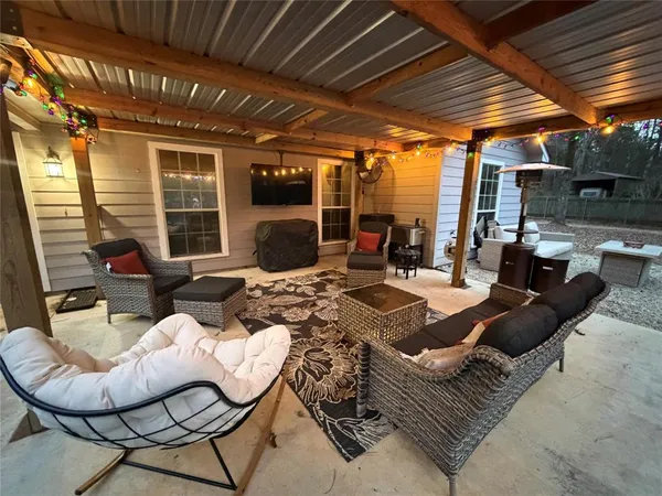 a front view of a house with yard and outdoor seating