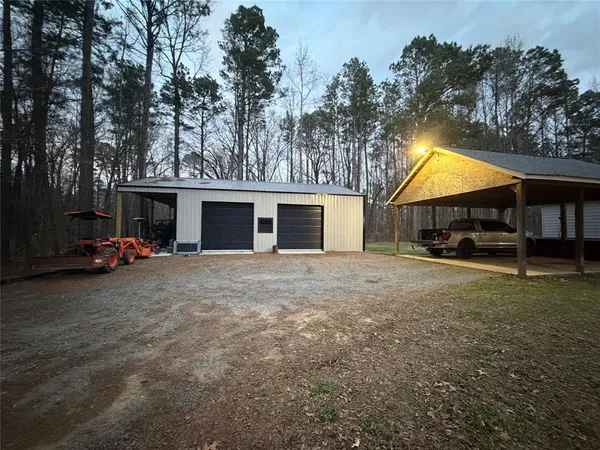 a view of a house with backyard and a tree