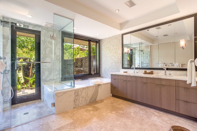 a large spacious bathroom with a large tub and shower