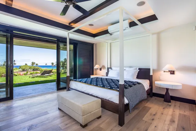 a spacious bedroom with a bed and a large window