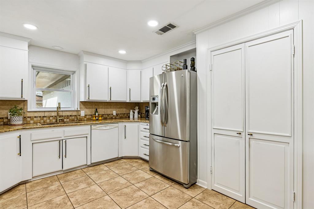 1012 Cowling Road Sanger, TX 76266 - Photo 14 of 40 a kitchen with white cabinets and refrigerator