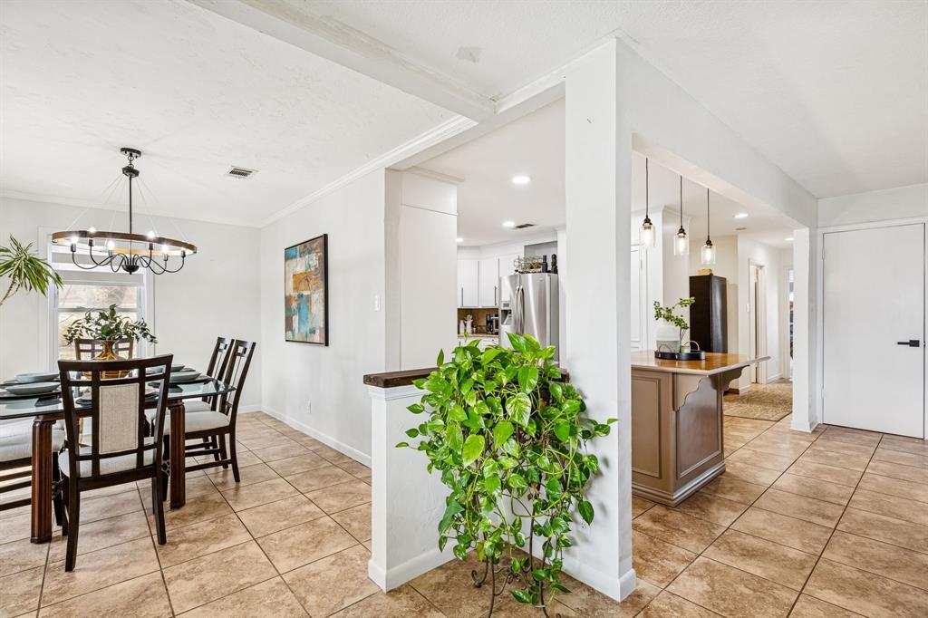 1012 Cowling Road Sanger, TX 76266 - Photo 15 of 40 a view of a dining room with furniture and a chandelier