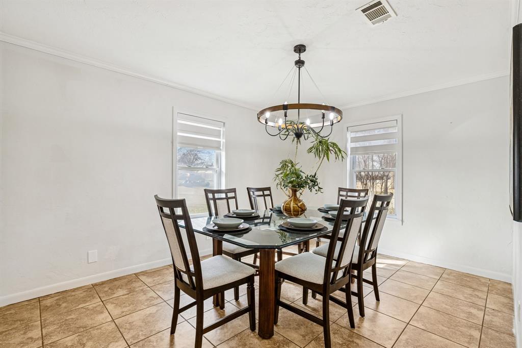 1012 Cowling Road Sanger, TX 76266 - Photo 16 of 40 a view of a dining room and a chandelier fan