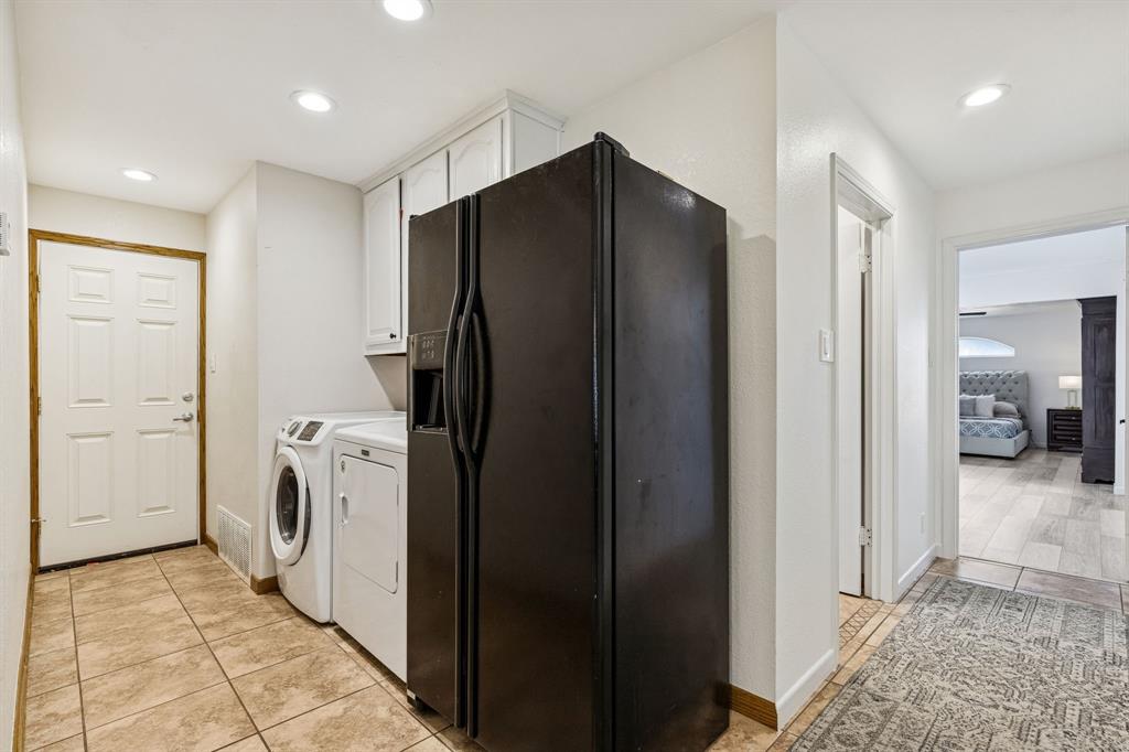 1012 Cowling Road Sanger, TX 76266 - Photo 18 of 40 a view of a hallway with a washer and dryer