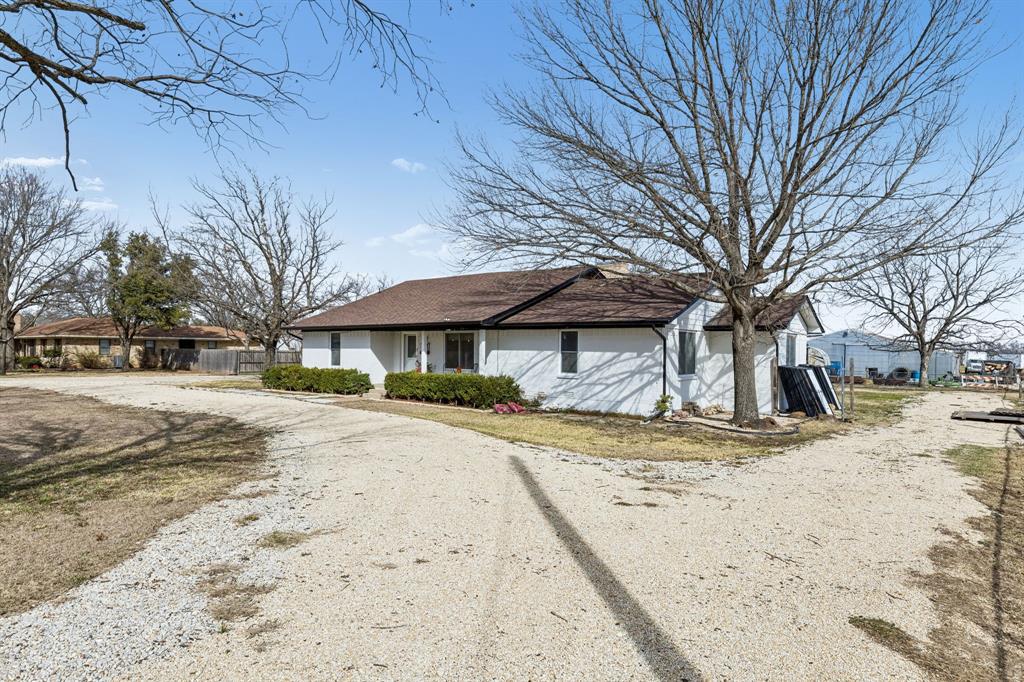 1012 Cowling Road Sanger, TX 76266 - Photo 2 of 40 a view of a yard with a tree
