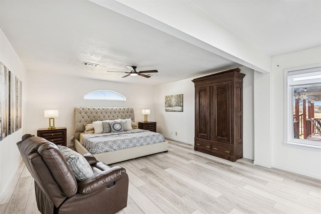 1012 Cowling Road Sanger, TX 76266 - Photo 21 of 40 a spacious bedroom with a large bed and a window