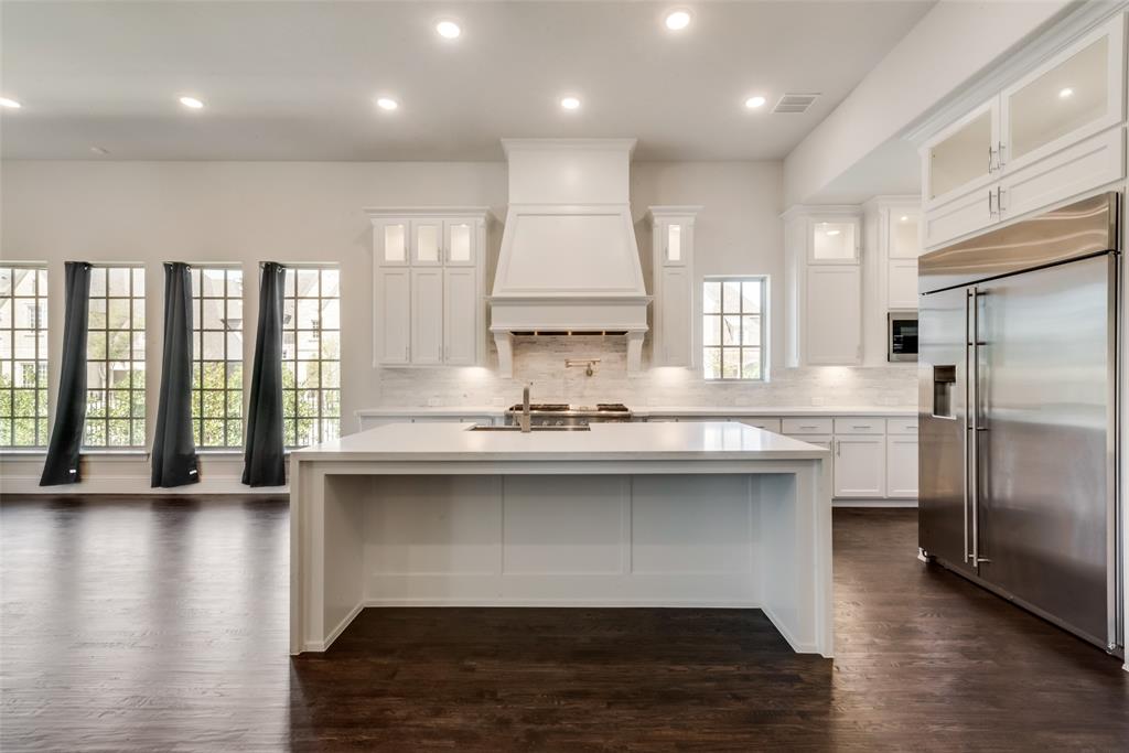 6887 Tranquility Court Frisco, TX 75034 - Photo 15 of 37 a kitchen with stainless steel appliances granite countertop a sink a stove and a refrigerator