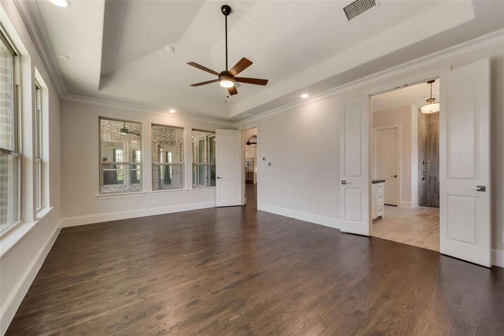 6887 Tranquility Court Frisco, TX 75034 - Photo 17 of 37 a view of an empty room with wooden floor and a window