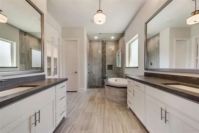 a spacious bathroom with a granite countertop sink mirror and a toilet