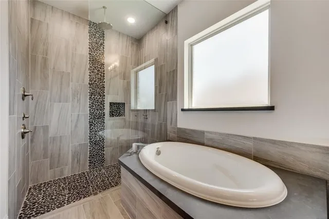 a bathroom with a bathtub and shower