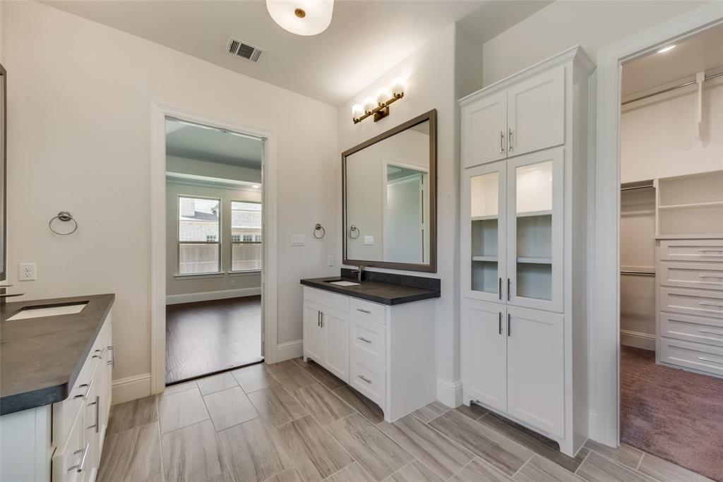 6887 Tranquility Court Frisco, TX 75034 - Photo 21 of 37 a kitchen with granite countertop a stove and a sink