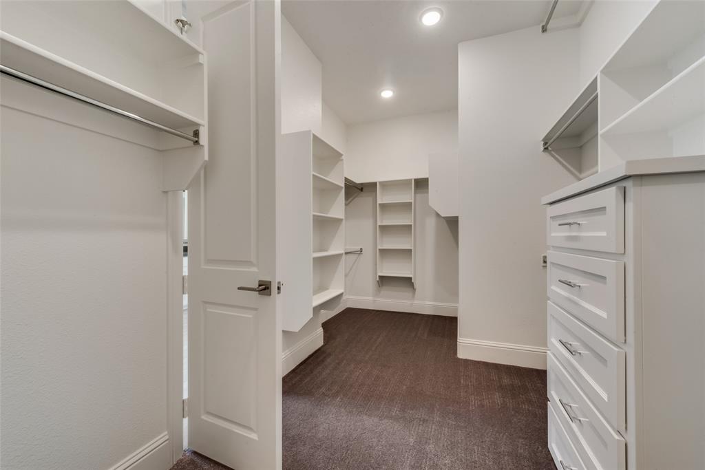 6887 Tranquility Court Frisco, TX 75034 - Photo 22 of 37 a view of walk in closet with empty racks
