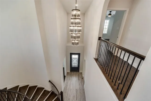 a view of a room with wooden floor and windows