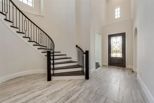 a view of entryway with wooden floor and stairs