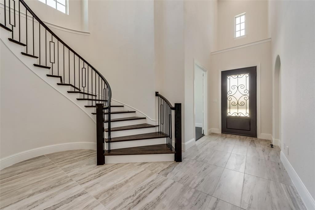 6887 Tranquility Court Frisco, TX 75034 - Photo 3 of 37 a view of entryway with wooden floor and stairs