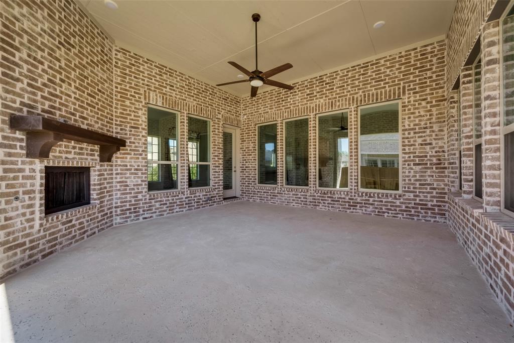 6887 Tranquility Court Frisco, TX 75034 - Photo 33 of 37 a view of a house with a fireplace and windows