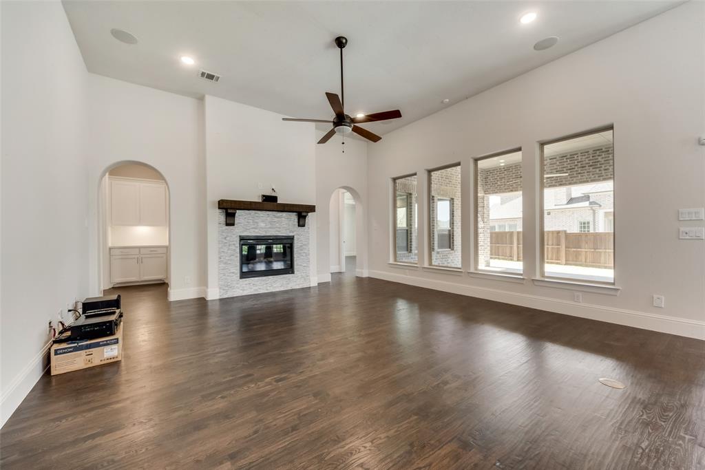 6887 Tranquility Court Frisco, TX 75034 - Photo 7 of 37 a view of an empty room with a window and wooden floor