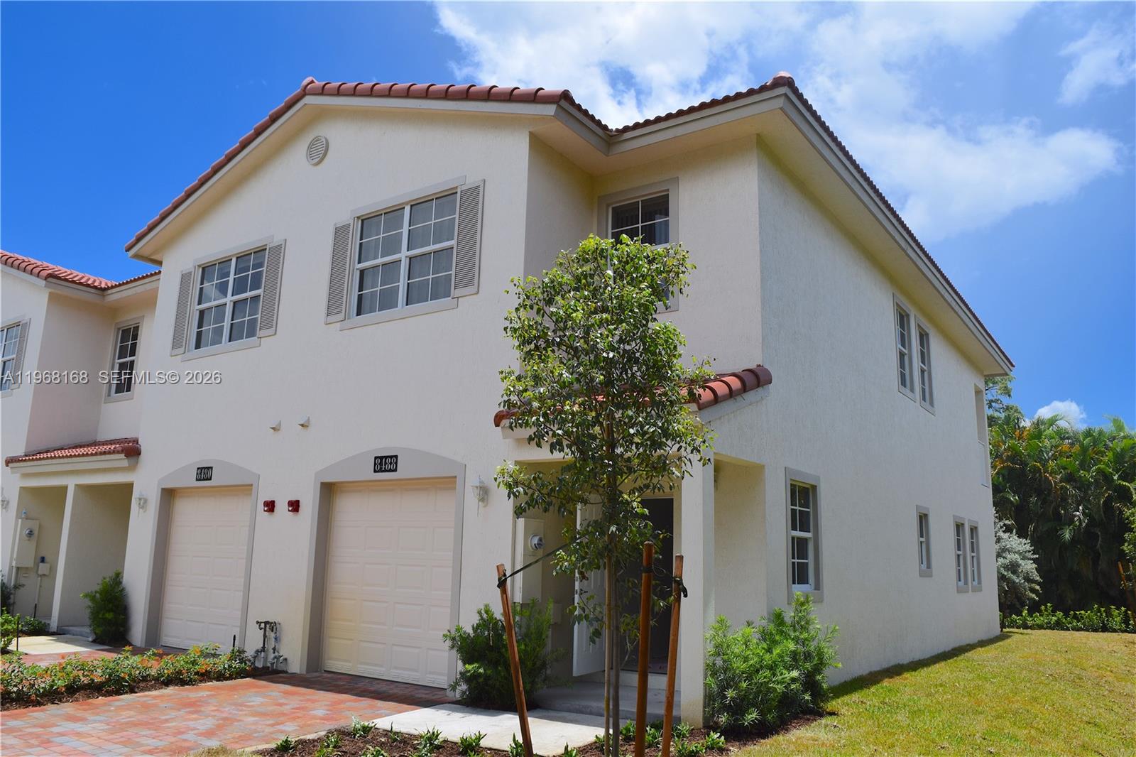 8440 West McNab Road, Unit 8440 Fort Lauderdale, FL 33321 - Photo 3 of 22 a front view of a house with plants