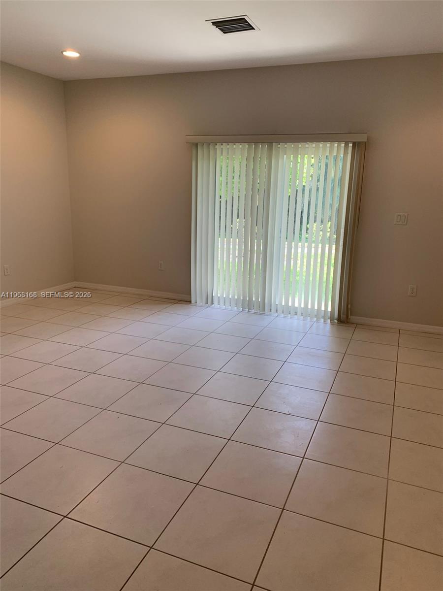 8440 West McNab Road, Unit 8440 Fort Lauderdale, FL 33321 - Photo 9 of 22 a view of an empty room and a window