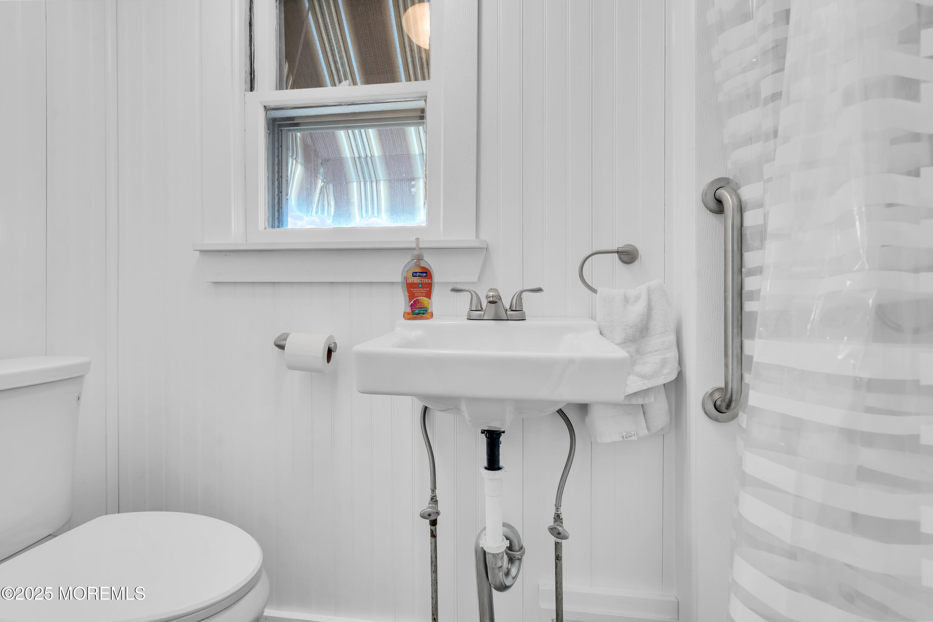 1812 Fernwood Road, Unit 2 Belmar, NJ 07719 - Photo 16 of 41 a bathroom with a sink a toilet and a window
