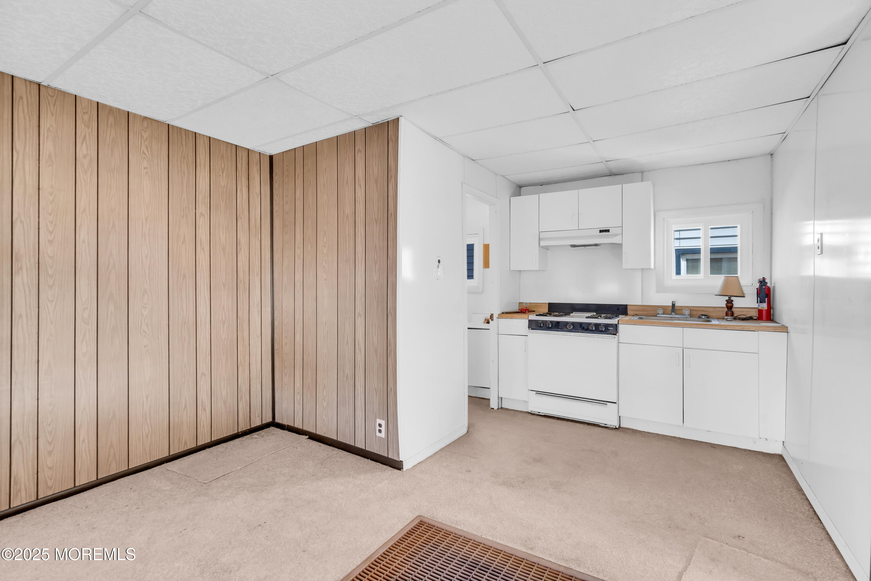 1812 Fernwood Road, Unit 2 Belmar, NJ 07719 - Photo 23 of 41 a kitchen with white cabinets and white appliances