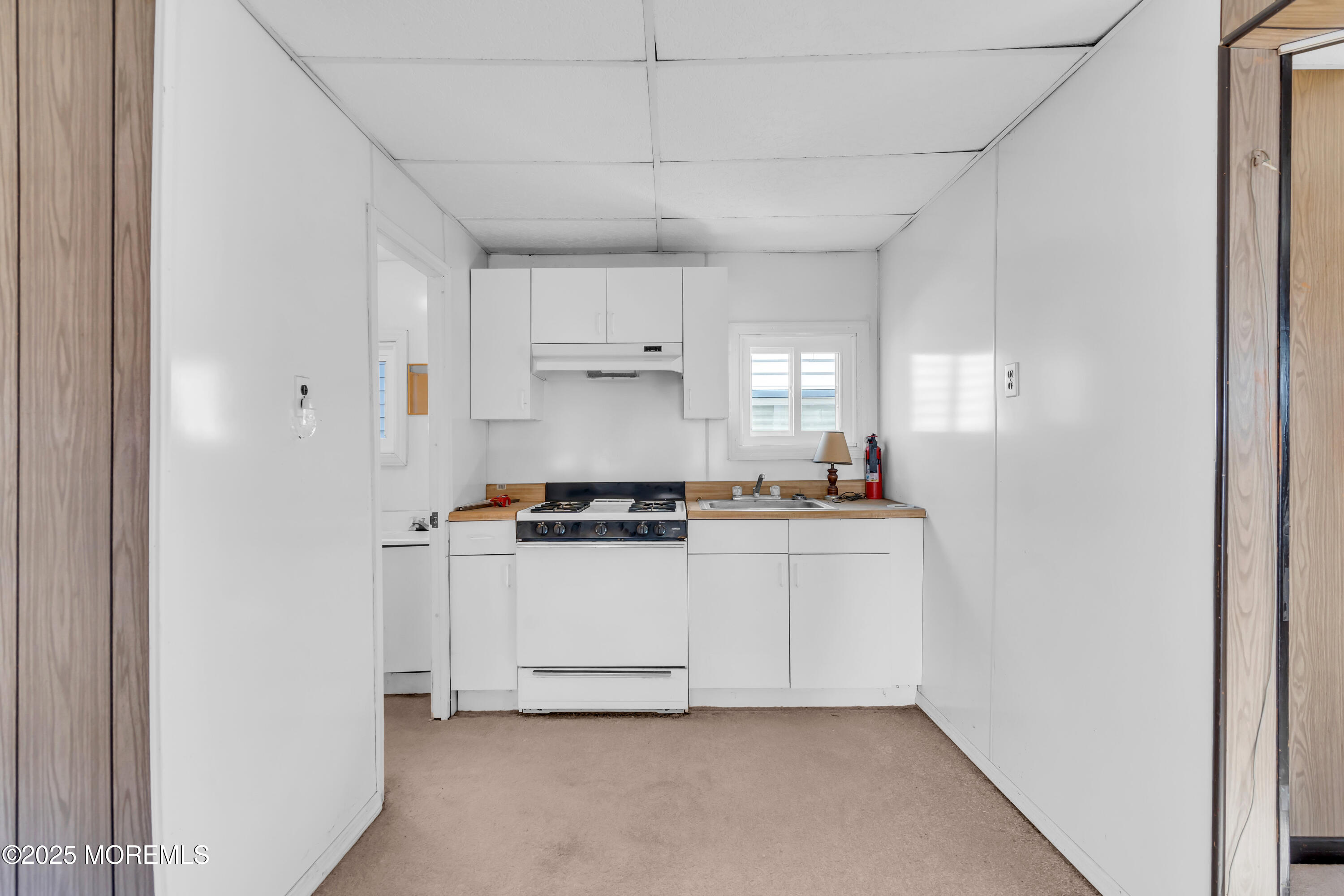 1812 Fernwood Road, Unit 2 Belmar, NJ 07719 - Photo 25 of 41 a kitchen with white cabinets and white appliances