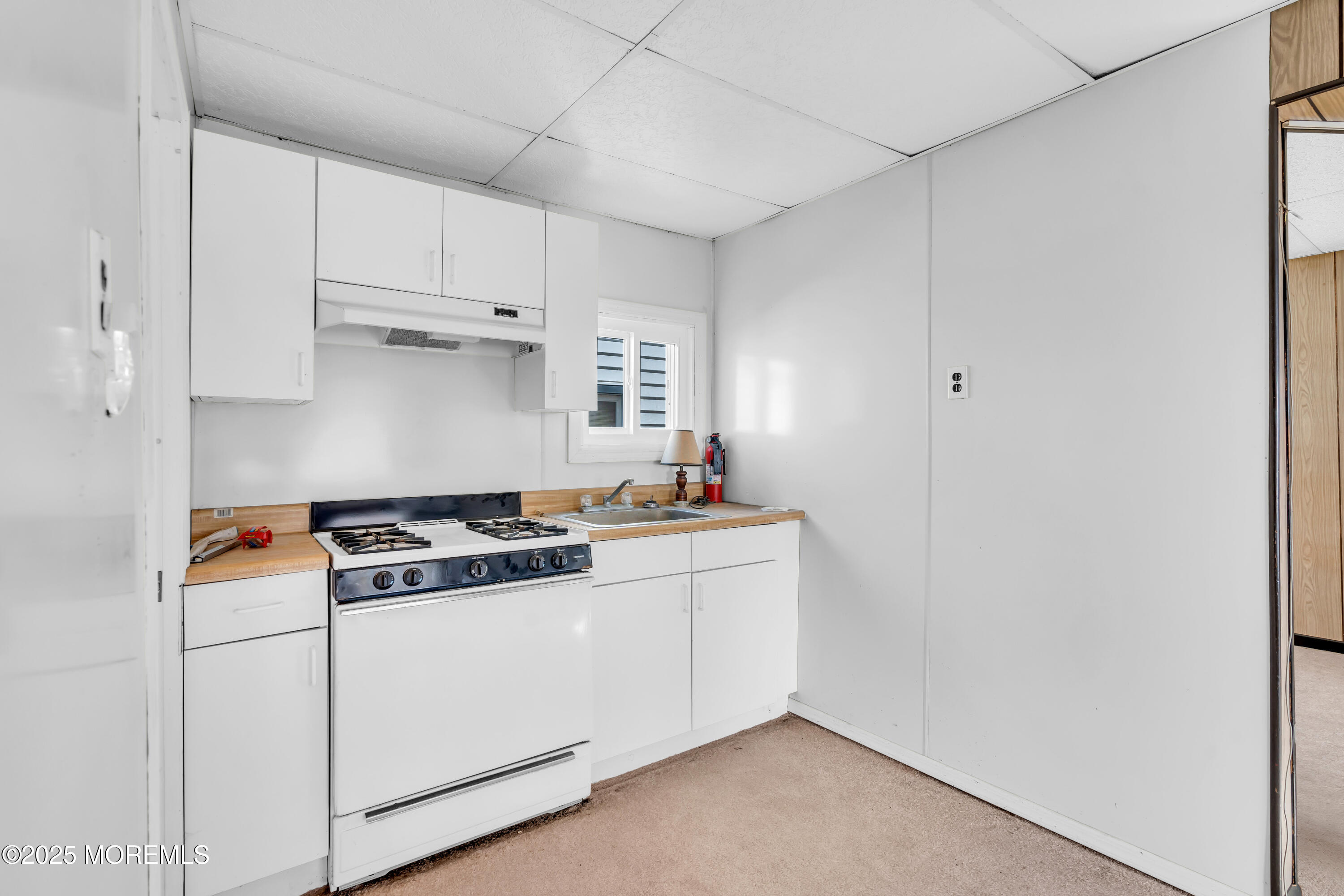 1812 Fernwood Road, Unit 2 Belmar, NJ 07719 - Photo 26 of 41 a kitchen with a stove and white cabinets