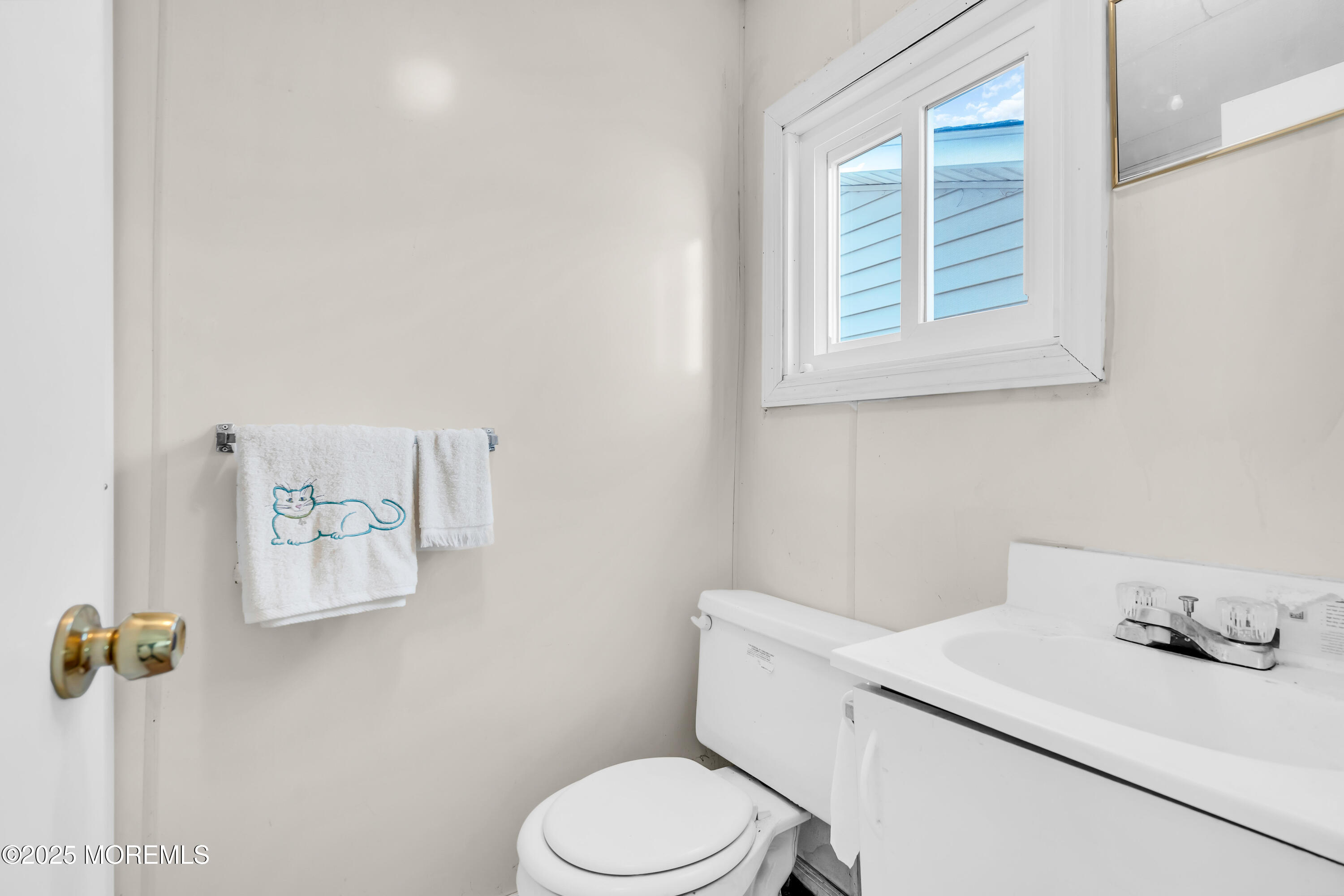 1812 Fernwood Road, Unit 2 Belmar, NJ 07719 - Photo 31 of 41 a bathroom with a toilet sink and mirror