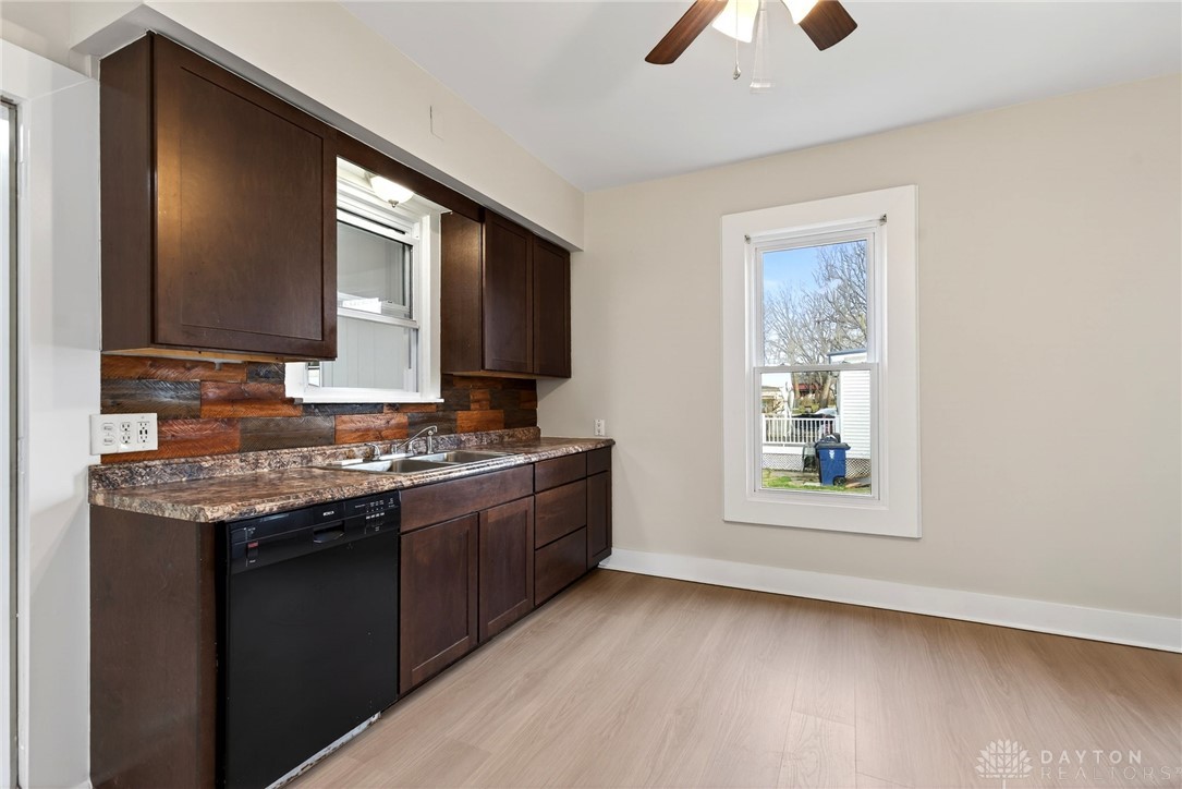 585 North Spring Street Wilmington, OH 45177 - Photo 7 of 21 This bright kitchen features ample cabinetry, durable countertops, and sleek appliances.