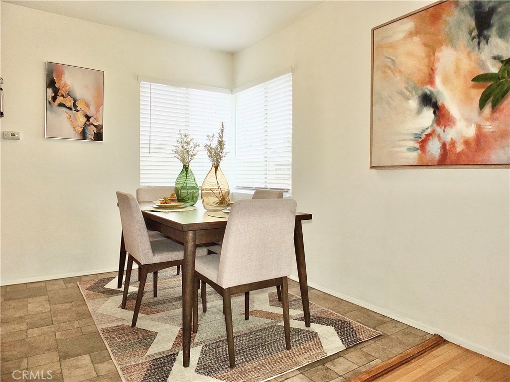 1335 East Appleton Street, Unit 8 Long Beach, CA 90802 - Photo 15 of 47 a view of a dining room with furniture window and wooden floor
