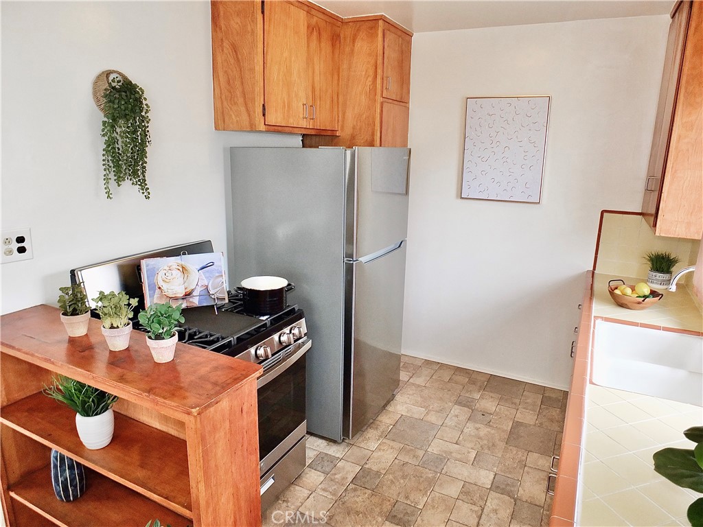 1335 East Appleton Street, Unit 8 Long Beach, CA 90802 - Photo 22 of 47 a kitchen with stainless steel appliances granite countertop a refrigerator and a stove