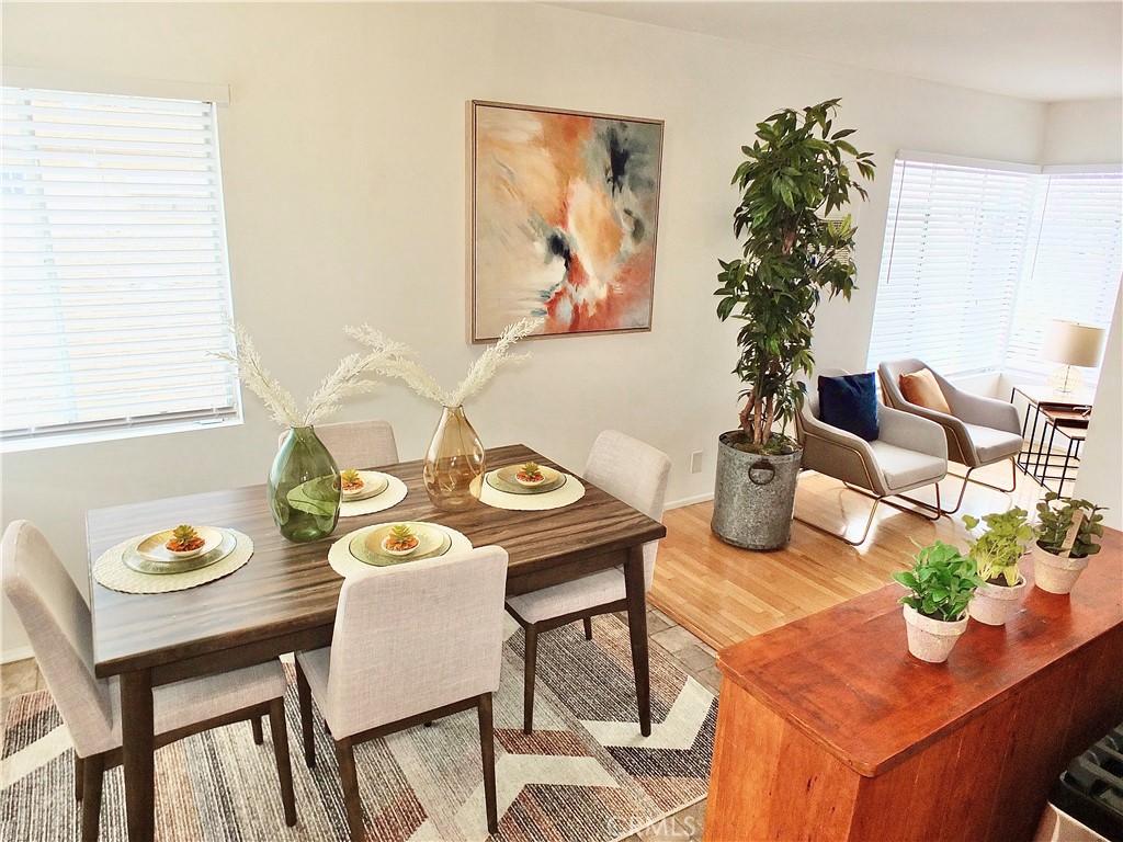 1335 East Appleton Street, Unit 8 Long Beach, CA 90802 - Photo 25 of 47 a view of a dining room with furniture a potted plant and wooden floor