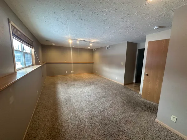 an empty room with projector and windows